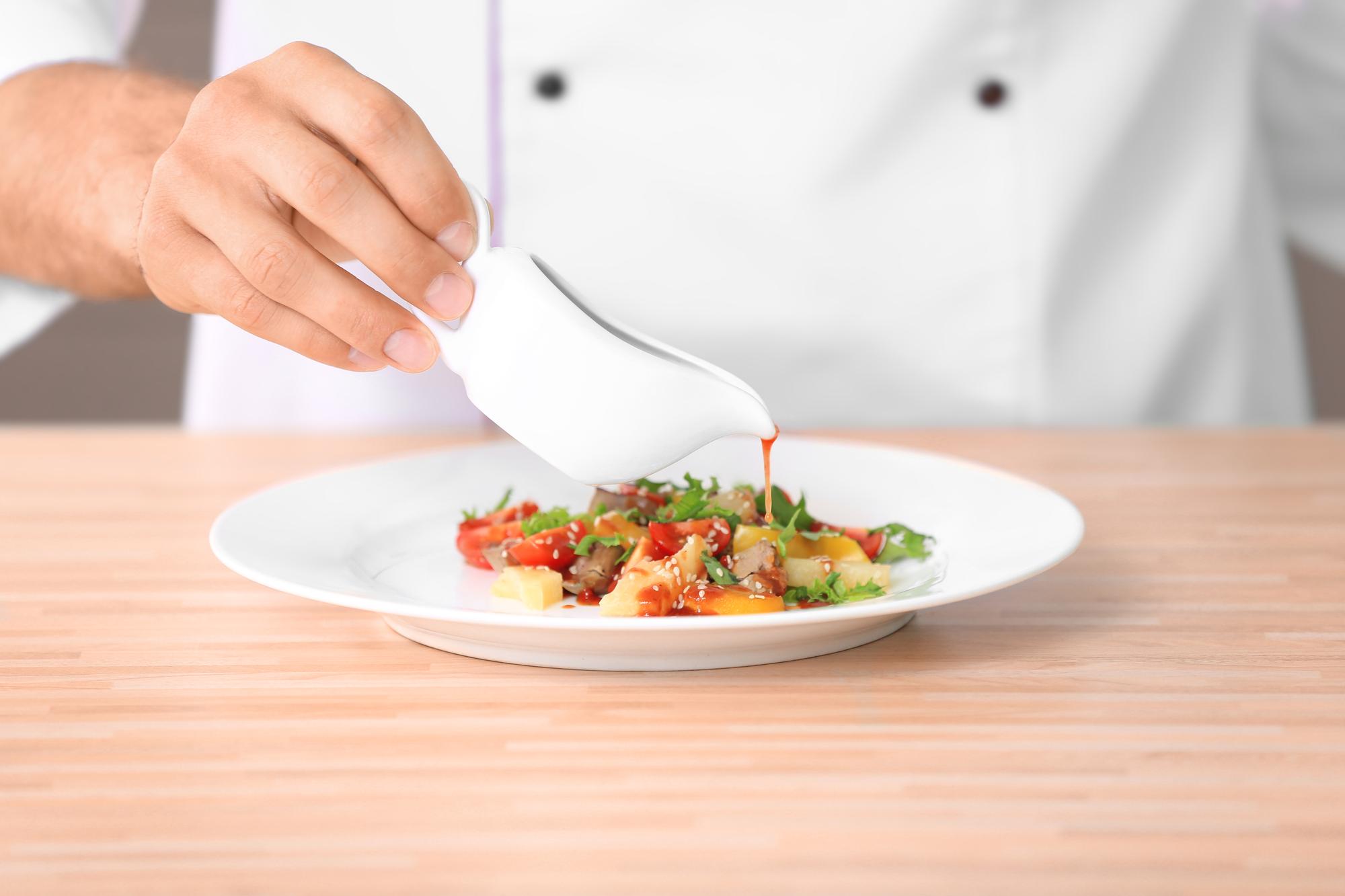chef preparing plated course in studio kitchen